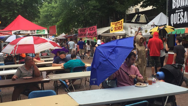 Rain reduced to a drizzle in the early evening, and a flow of pedestrian traffic steadily returned to the three-day festival that celebrates artistry and Ithaca pride.