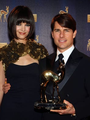 Tom Cruise poses with his wife Katie Holmes and the