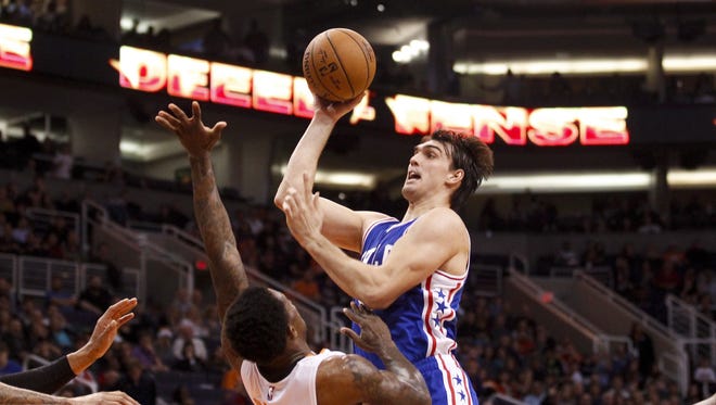 76ers forward Dario Saric (9) misses a jumper as Suns guard Eric Bledsoe (2) defends in the fourth quarter at Talking Stick Resort Arena in Phoenix on Friday, Dec. 23, 2016.