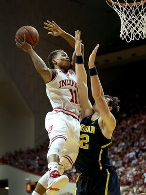 Indiana Hoosiers guard Yogi Ferrell (11) drives on and is fouled by Michigan Wolverines forward Ricky Doyle (32) in the first half of their game Sunday, Feb. 8, 2015. Indiana won 70-67 at Assembly Hall in Bloomington.