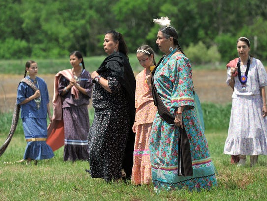 Casey Camp-Horinek leads a group of native dancers