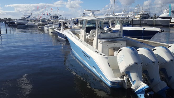 A Hydra Sports center console outfitted with four 350 horsepower Yamaha outboard motors sits tied alongside the center floating dock that leads to the extensive MarineMax display at this year's Stuart Boat Show.