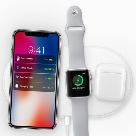 iPhone X, Apple Watch, and Airpods charging on...
