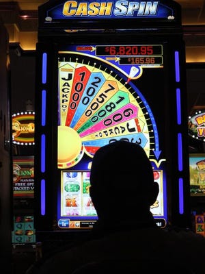 
People try their luck at the video gaming machines at the Empire City Casino at Yonkers Raceway in Yonkers. 
