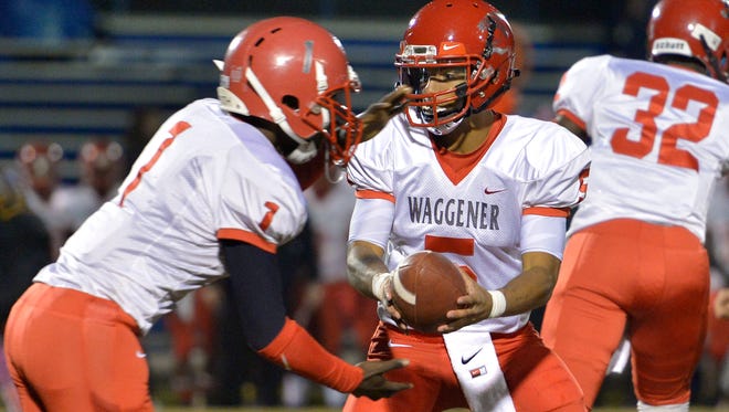 Waggener High School quarterback Larry Harper hands the ball off to running back Frank Bryant during the game against Valley at Valley High School.