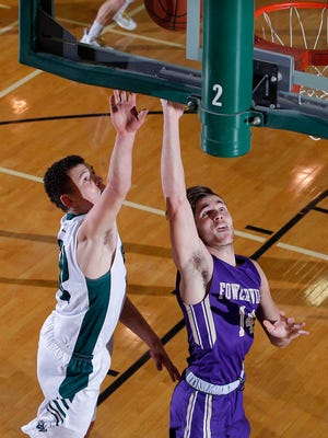 Fowlerville's Geoffrey Knaggs, right, gets a layup against Williamston's Sean Cobb, Friday, Jan. 12, 2018, in Williamston, Mich. Williamston won 99-66.