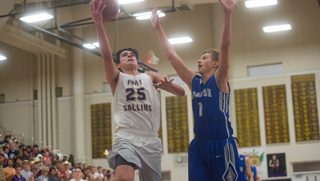 Sam Tiley of Fort Collins High School gets around Impalas defender Hunter Bernhardt to shoot from under the basket during a game against Poudre on Tuesday, February 6, 2018. Tiley had a team-high 23 points.