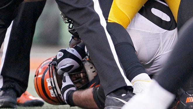 Pittsburgh Steelers guard David DeCastro (66) grips the face mask of Cincinnati Bengals defensive end Wallace Gilberry (95) at the bottom of a scrum in the fourth quarter of the NFL Week 14 game between the Cincinnati Bengals and the Pittsburgh Steelers at Paul Brown Stadium in downtown Cincinnati on Sunday, Dec. 13, 2015. The Bengals fell to 10-3 with a 33-20 loss to the Steelers.