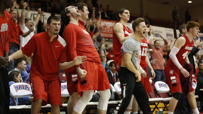 Indiana Wesleyan's bench celebrates during the final moments of the NAIA national championship game.