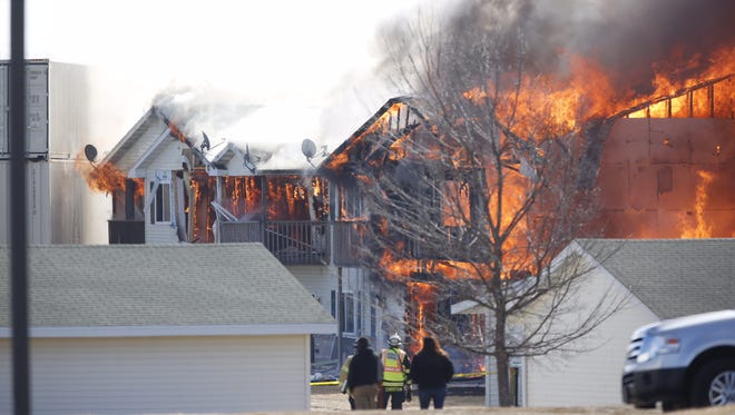 Village Glen Apartments' Building 109 stands fully engulfed in flames during a controlled burn on March 15.