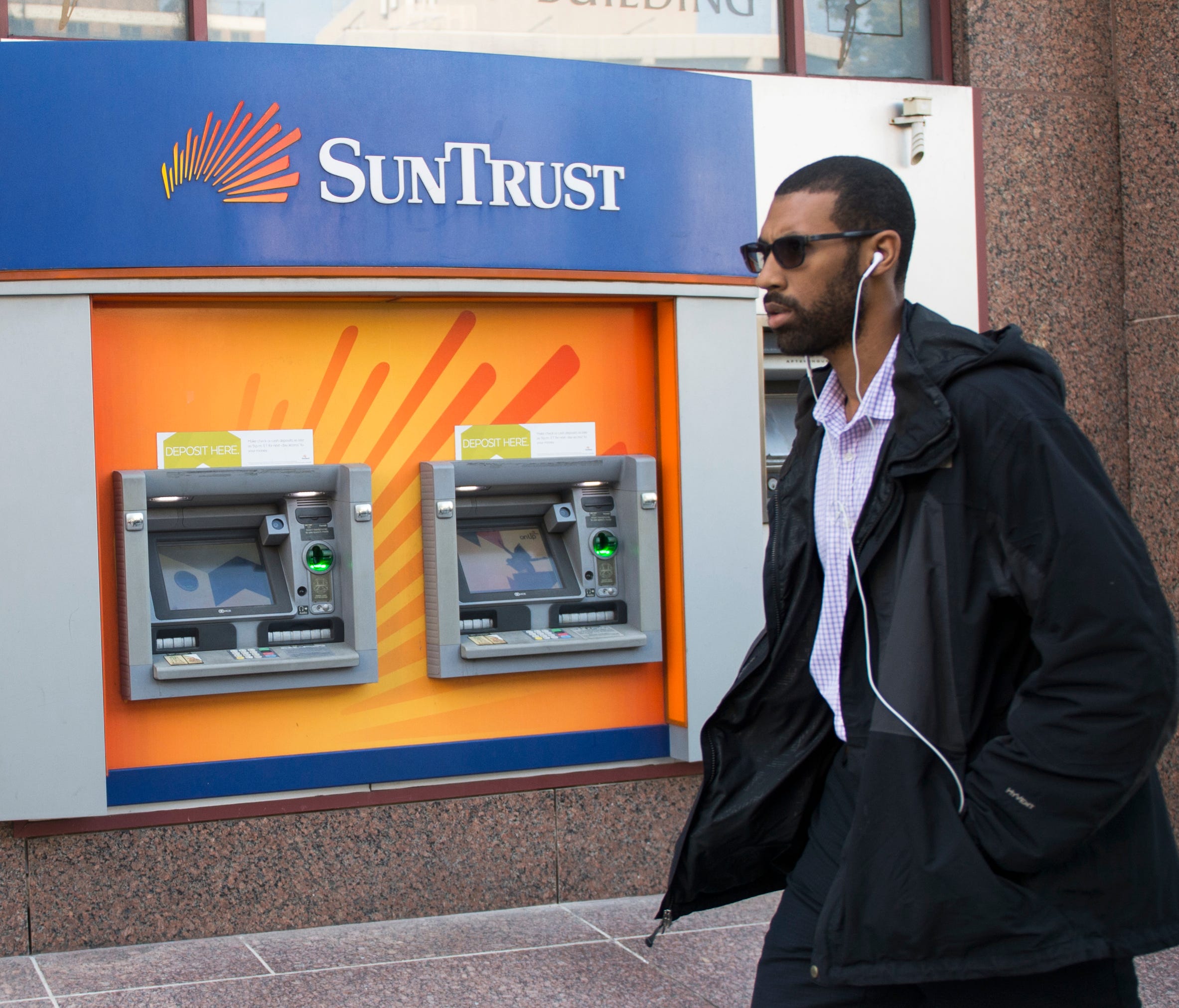 A man walks past a SunTrust bank ATM Oct. 11, 2016 in Washington, DC.