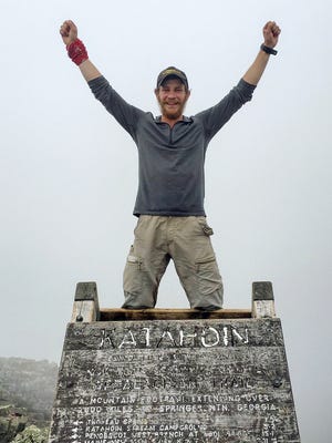 Jackson Spencer poses atop Mount Katahdin along the Appalachian Trail near Millinocket, Maine, on Aug. 5. Spencer, who finished the entire trail in just 99 days, said he was looking forward to enjoying the wilderness and getting away from it all. Instead he often found the trail filled with trash, graffiti and people who seemed more interested in partying all night.
