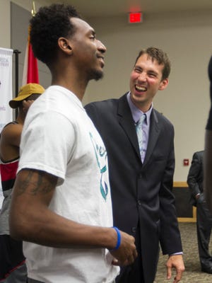 Marty Richter laughs with former FGCU player Bernard Thompson on Wednesday after Richter was introduced as the new men's basketball coach at Florida SouthWestern State College. Richter is the associate head coach at FGCU.