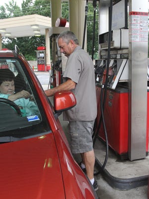 Mary Watts pays owner Chip Wagoner for her full service fill-up at the Brentwood Service Station. Below, right: Bonnie Massey has worked here for 34 years.<137>on Thursday, September 11, 2014. <137><252><137>Bonnie Massey talks with a customer at Brentwood Service Station on Thursday, September 11, 2014.<252><137>