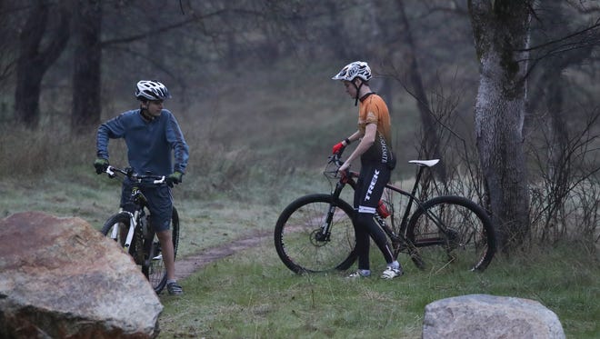 Redding Composite mountain biking team co-captains Ryan Pendergast, left, and Zach Haverty talk before going on a practice ride Thursday with other members of the team at Swasey Recreation Area in Redding.