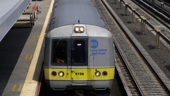 A Long Island Railroad train pulls into the Woodside stop in the Queens borough of New York, Tuesday, July 15, 2014. Union negotiators said Monday that weekend talks had collapsed amid a dispute over whether future Long Island Rail Road employees should be required to contribute to their health insurance and pensions. (AP Photo/Seth Wenig)