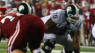 Left guard Tyler Higby (70) lines up while MSU quarterback Tyler O'Connor calls a play Saturday in Bloomington, Indiana.