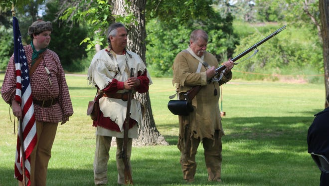Re-enactors from the Lewis and Clark Foundation prepare to present the colors during the 28th annual Lewis and Clark Festival at Gibson Park in Great Falls