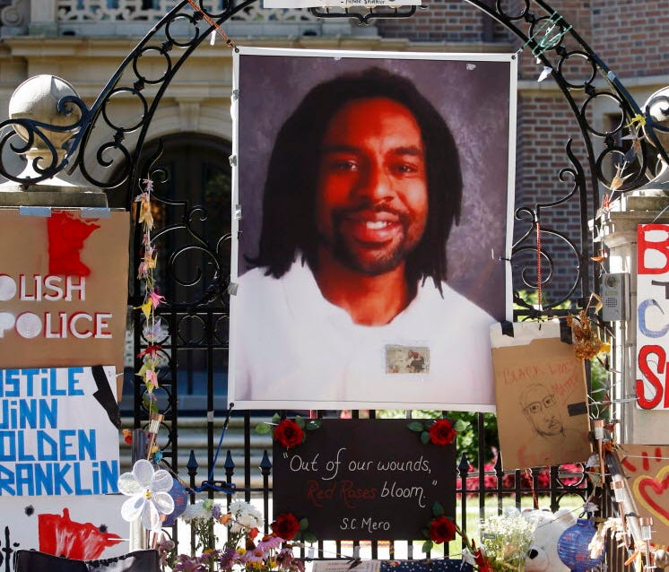 A memorial including a photo of Philando Castile adorns the gate to the governor's residence in St. Paul, Minn., on July 25, 2016.