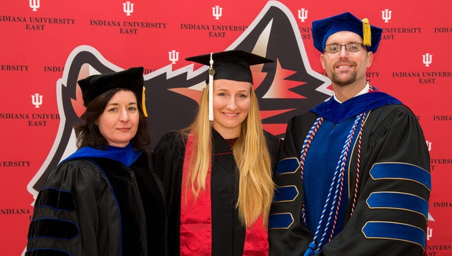 Alla Kudryavtseva, center,  receives her Bachelor of Arts in Communication Studies degree from IU East Executive Vice Chancellor Michelle Malott and School of Humanities and Social Sciences Dean Ross Alexander at IU East.