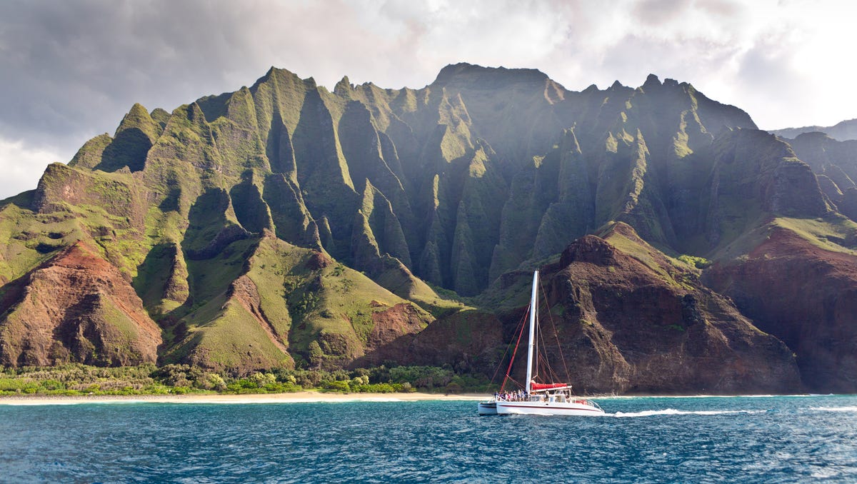 Sail the Napali Coast, Kauai: Native islanders say the Napali Coast nourishes the soul. This 17-mile stretch of rain-carved cliffs and emerald valleys is punctuated by thin, ribbonlike waterfalls, secret beaches, and sea caves teeming with aquatic life. With the spectacular Kalalau Trail currently closed to travelers due to flooding, the only way to access the cliffs is by sea. Imagine standing on the deck of a catamaran   beneath 4,000-foot cliffs to soak in mana, or spiritual power, before sliding into the water for snorkeling among green sea turtles and schools of eel and angelfish. When the trade winds are smooth, expect your catamaran to cruise around or even through the sea caves, its sails flapping the mast and spinner dolphins leaping at its stern.