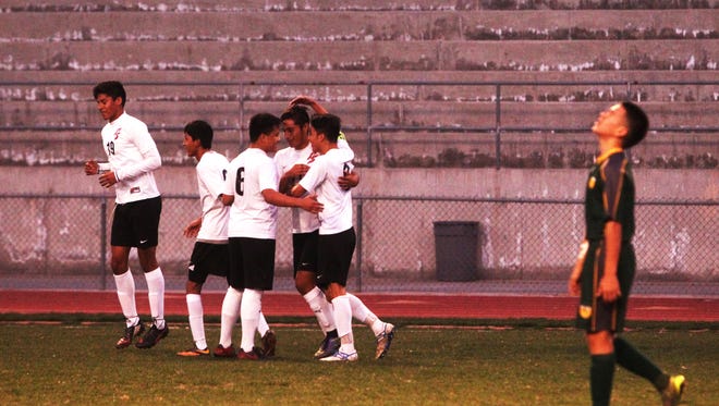 Palm Springs High School players celebrate their third goal in the first half of their game against Coachella Valley High School at home on January 21, 2016. 