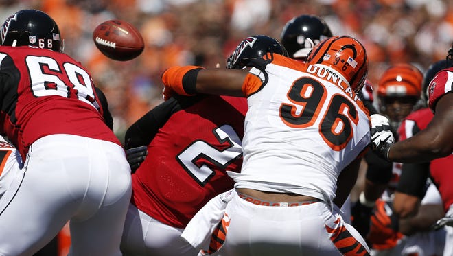 Bengals defensive end Carlos Dunlap forces an incomplete pass with one of his five hits Sunday on Falcons quarterback Matt Ryan.
