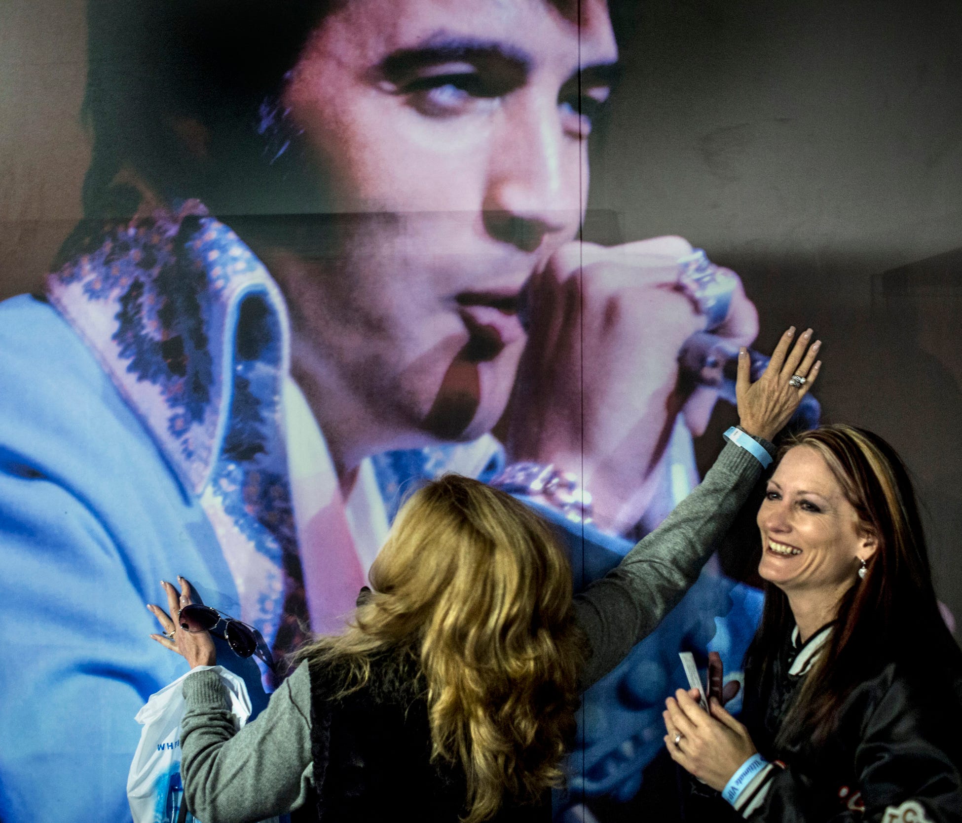 March 2, 2017 - Shelley Dorazio, left, embraces a picture of Elvis Presley while Jenny Furr laughs inside of the new Elvis Presley's Memphis. Elvis Presley Enterprises opened 200,000 square feet of new exhibits, museums and performance space behind G