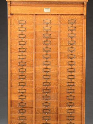 This 48-drawer filing cabinet was used to store folded business mail in the late 19th century. But mail is now filed in page size folders in a file with much larger drawers. It was repurposed into a storage cabinet for jewelry or some other small items. The price at auction was $1,331.