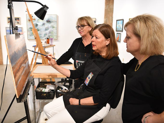 Mary Kimball, left, and Lysle Huddleston, right, talk