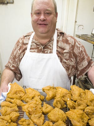 Mary's Fabulous Chicken & Fish owner Eric Wolf holds a tray of fried chicken fresh from the fryer. Mary's won the 2014 Daily Press & Argus Restaurant Poll for best chicken.