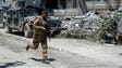 A member of the Iraqi forces runs with his weapon as