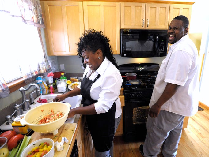 Maurice Webb and his wife, Neisy, share a laugh while