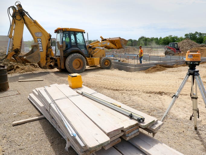 Contractors backfill the foundation for a concessions