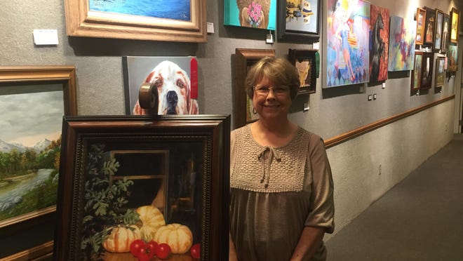 Artist Gladys Tweedy stands next to a painting entered in the 2016 Spring Art Show. An artists’ reception is set for today. The show runs until May 21.