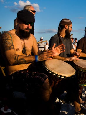 Drummers keep the beat together during the community drum circle at Siesta Key Beach on Sunday, January 21, 2018 in Sarasota. 