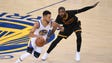 Stephen Curry dribbles past Kyrie Irving during the