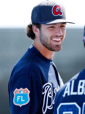 Dansby Swanson talks with shortstop Ozzie Albies (87) prior to a recent Atlanta Braves spring training game.