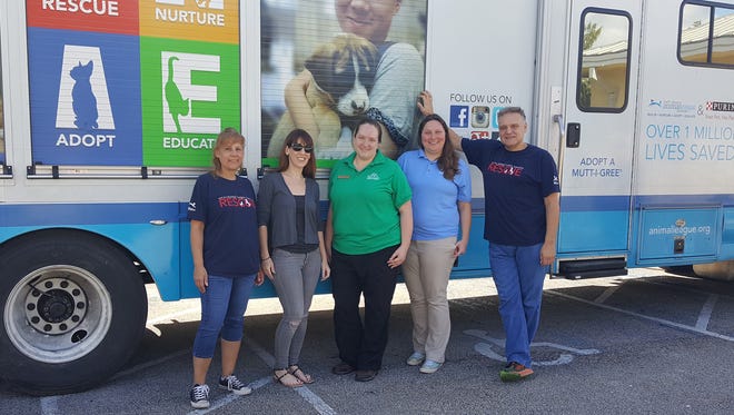 HSTC Foster & Rescue Coordinator Emily Recco and Adoption Manager Deidre Huffman (center) are flanked by North Shore Animal League America transport staff.