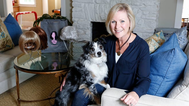 Breast cancer survivor Kate Conn is the co-founder of the Wig Exchange, an organization that has loaned out more than 300 wigs to local breast cancer patients since 2012. Kate with her dog, Phinn, at home in Rye.
