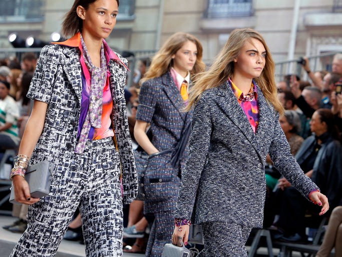 Model Cara Delavingne, right, and other models wear creations as part of Chanel's Spring/Summer 2015 ready-to-wear fashion collection presented in Paris Tuesday, Sept. 30, 2014.