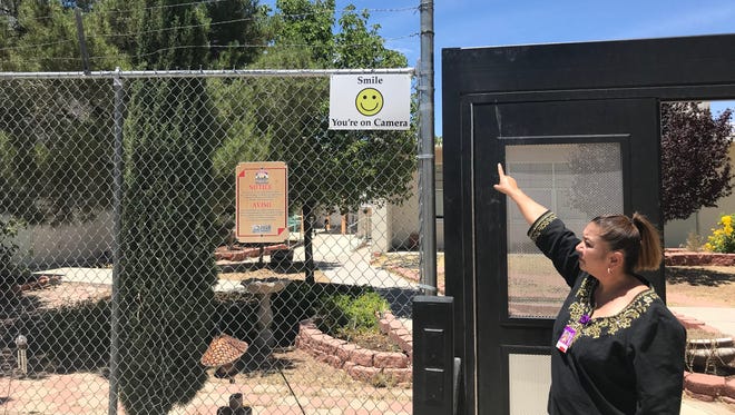 Valley View Elementary Principal Elosia Solis points to a fence that three suspects, believed to minors, scaled to break into the school early Sunday, May 28, 2018.