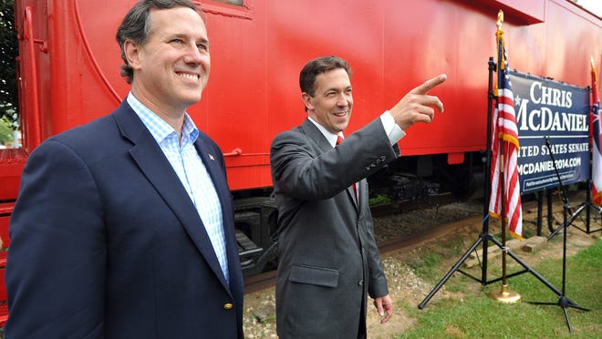 Former Sen. Rick Santorum, left, and Senate candidate Chris McDaniel, greet supporters.