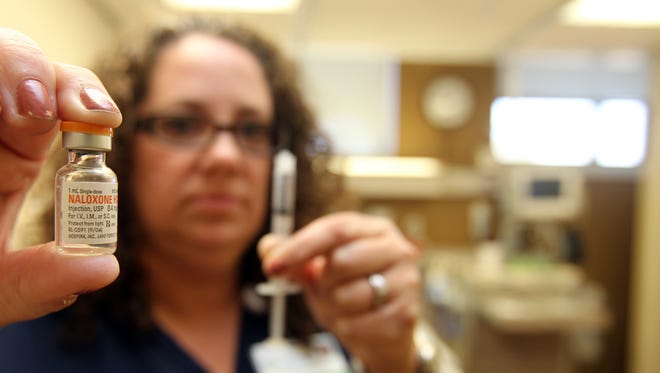 Ashel Kruetzkamp, nurse manager of the emergency department at St. Elizabeth Hospital, with a vial of Naloxone HCl, which is generic Narcan. The drug is used to treat persons who have overdosed on heroin.