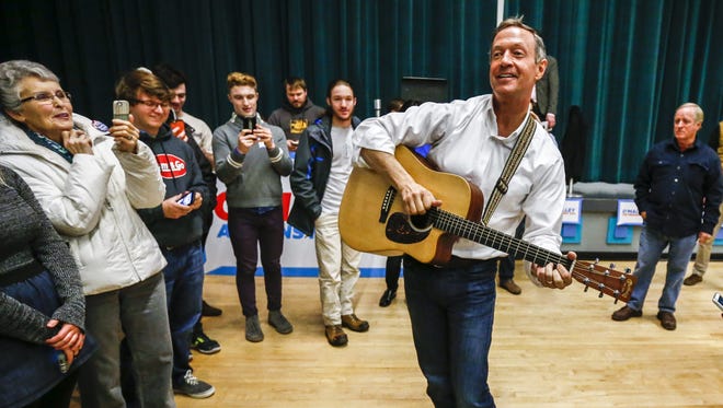 Former Maryland governor Martin O'Malley plays a guitar and sings after speaking at a campaign event at Grinnell College in Grinnell, Iowa.