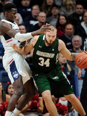Wagner's Mike Aaman drives against Connecticut's Amida Brimah Friday.