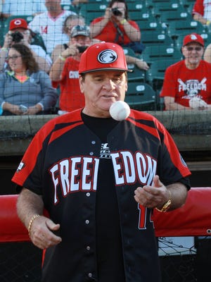 Pete Rose tosses a baseball before a Florence Freedom game in September. Rose coached first base for the Freedom during the game.