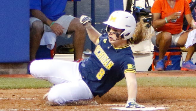 Michigan outfielder Nikki Wald (8) beats the ball to home plate in the sixth inning Monday in Oklahoma City.