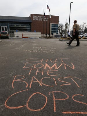 Graffiti in the parking lot of the Ferguson Police Department in Ferguson, Mo., in March 2015.