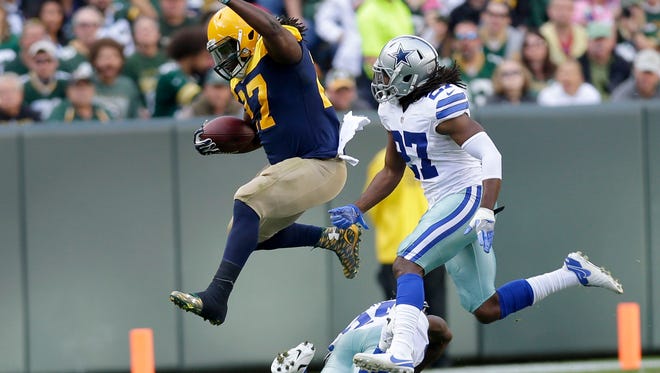 Green Bay Packers running back Eddie Lacy (27) leaps over a Dallas defender during the 2nd quarter of the game at Lambeau Field on Sunday, October 16, 2016.